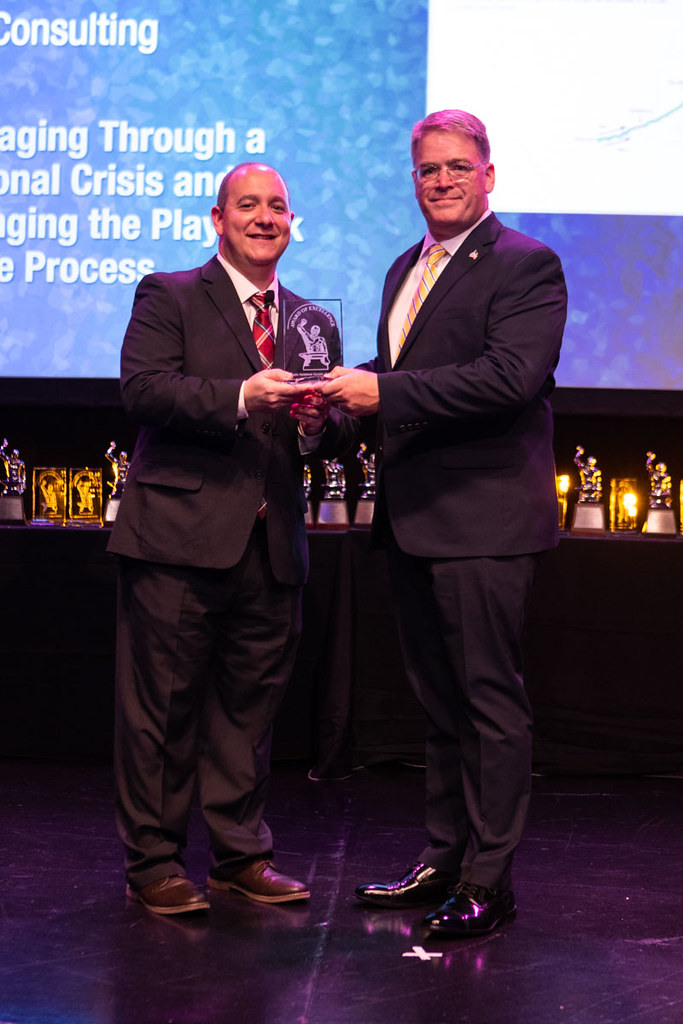 two businessmen accepting an award