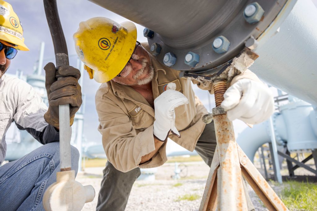 employees working on an oil and gas pipeline